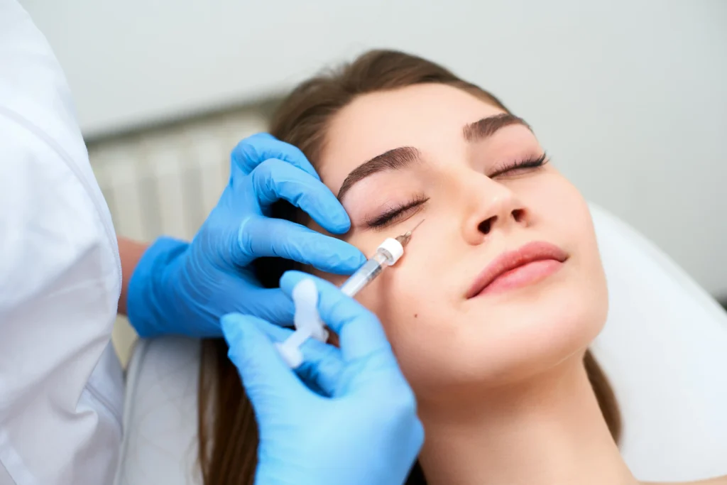 Medical professional performing Xeomin under-eye injection on a relaxed female patient at Mederna Aesthetic & Wellness Medical Center in Houston, TX.