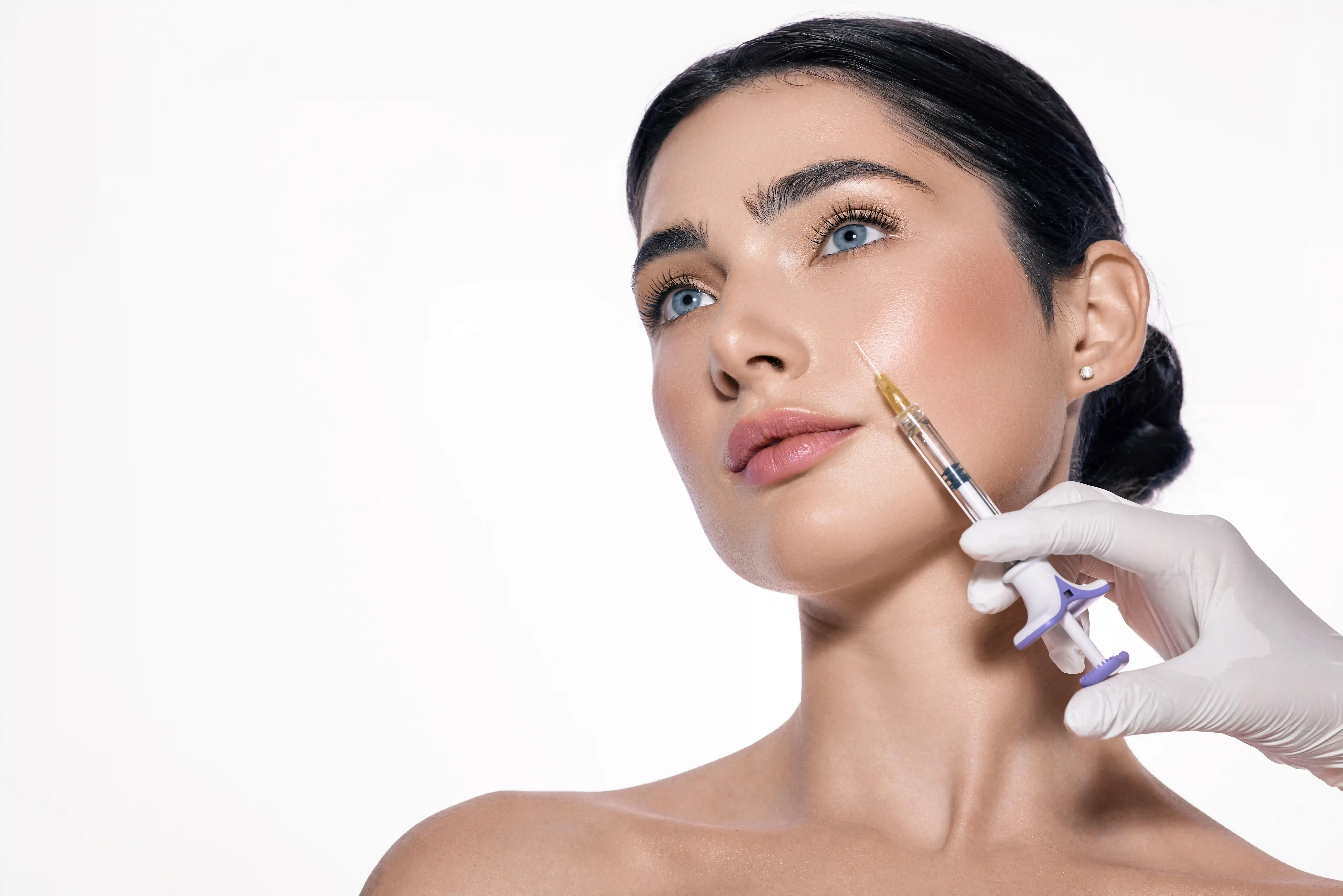 Xeomin injection being administered to a woman’s cheek by a medical professional at Mederna Aesthetic & Wellness Medical Center in Houston, TX.